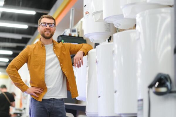 smiling-male-customer-looking-domestic-boilers_255667-76510